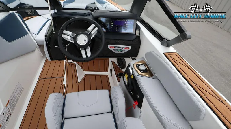 Slide: The Image of 2024 Nautique GS24 boat cockpit with modern steering wheel and touchscreen display. - 43