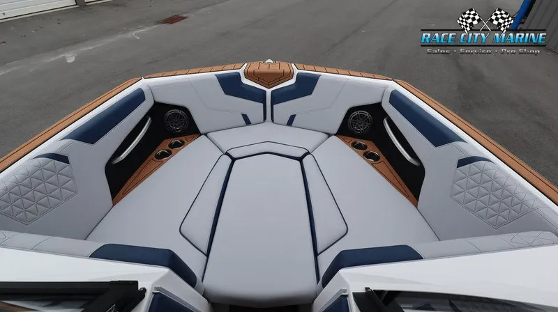 Slide: The Image of 2024 Nautique GS24 boat interior with luxurious seating and cup holders. - 44