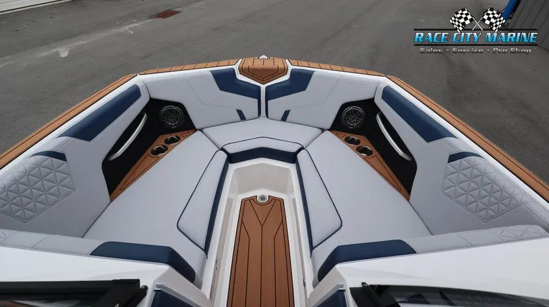 Slide: The Image of 2024 Nautique GS24 boat interior with luxurious seating and teak accents. - 45