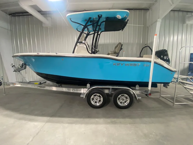 The Image of 2024 Key West 219 FS boat on a trailer in a showroom. - 0