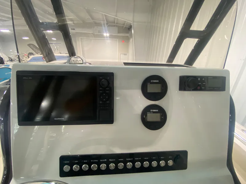 Slide: The Image of 2024 Key West 219 FS boat dashboard with Garmin display and Yamaha gauges. - 12