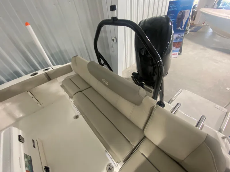 Slide: The Image of 2024 Key West 219 FS boat interior with seating and outboard motor. - 6