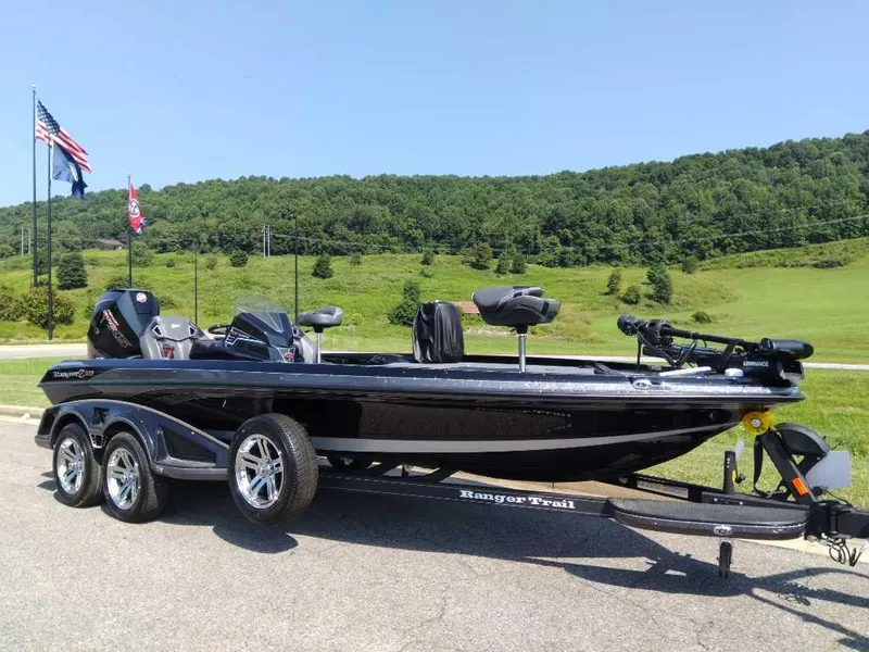 Slide: The Image of 2024 Ranger Z521R Ranger Cup Equipped boat on a trailer in a scenic outdoor setting. - 0