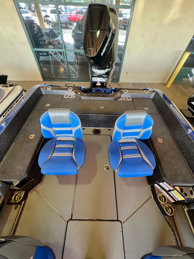 Slide: The Image of 2024 Ranger 621FS Ranger Cup Equipped boat with blue seats and powerful outboard motor. - 3