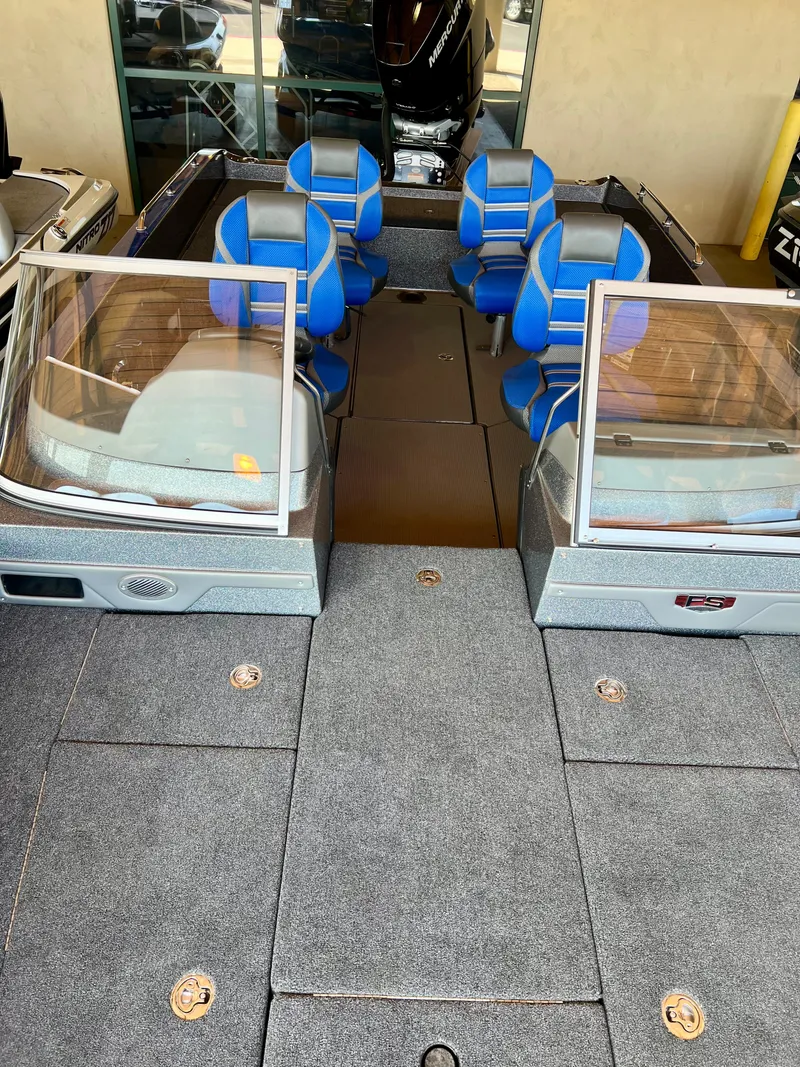 Slide: The Image of 2024 Ranger 621FS Ranger Cup Equipped boat interior with blue seats. - 4