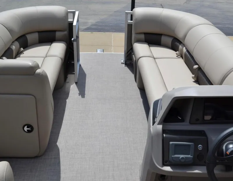 Slide: The Image of 2024 Sun Tracker Party Barge 20 DLX interior with beige seating and control console. - 2