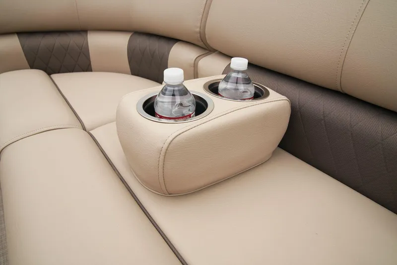 Slide: The Image of Sun Tracker Party Barge 20 DLX 2024 interior with cup holders and water bottles. - 28