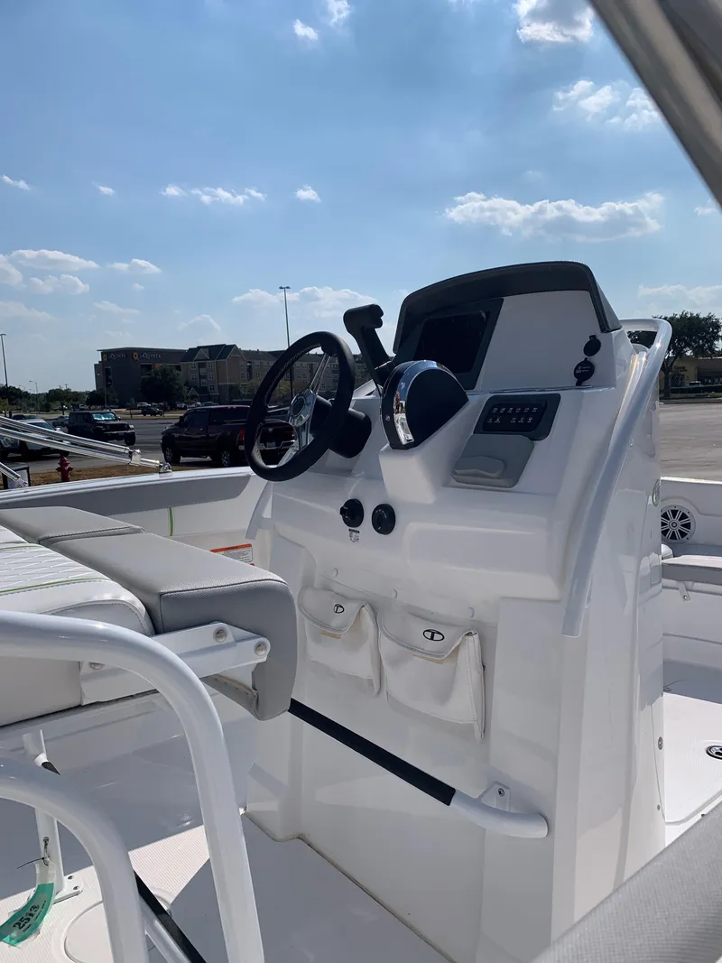 Slide: The Image of 2024 Tahoe 2150 CC boat console with steering wheel and controls. - 1