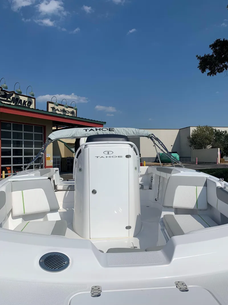 Slide: The Image of 2024 Tahoe 2150 CC boat, white interior, outdoor showroom display. - 2