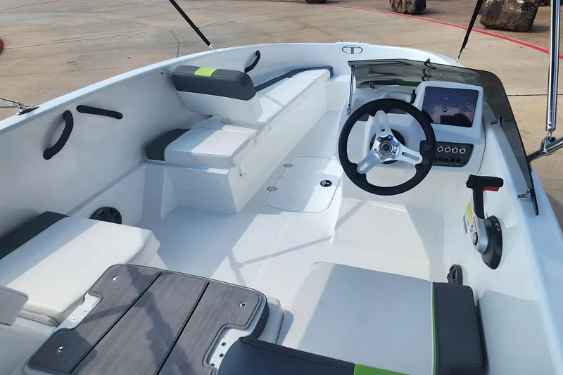 Slide: The Image of 2024 Tahoe T16 boat interior with steering wheel, seating, and control panel. - 1