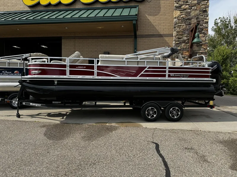 The Image of 2024 Ranger Reata 220F pontoon boat displayed outside a store. - 0