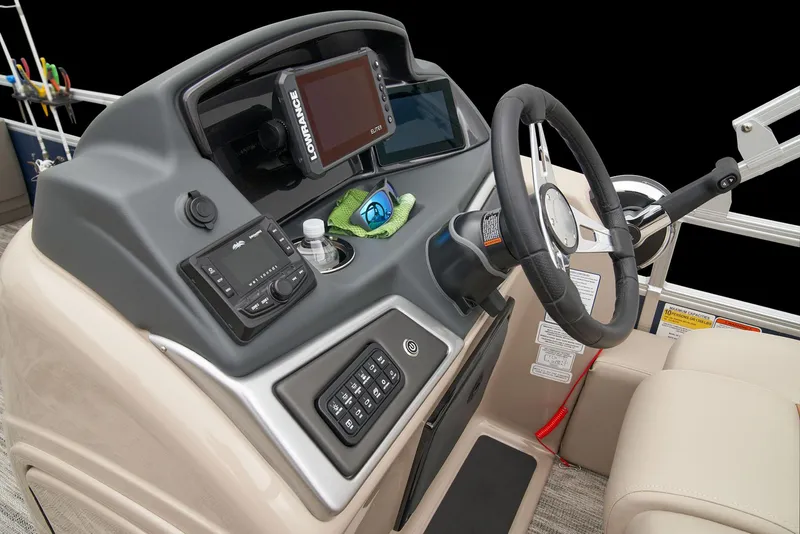 Slide: The Image of 2024 Ranger Reata 220F boat dashboard with steering wheel and electronic controls. - 31
