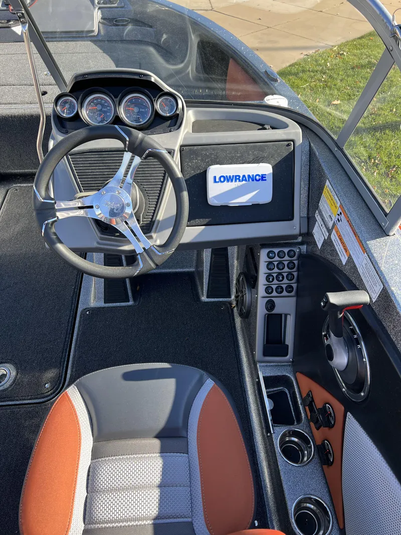 Slide: The Image of 2024 Ranger 1850MS boat dashboard with Lowrance electronics and modern steering wheel. - 8