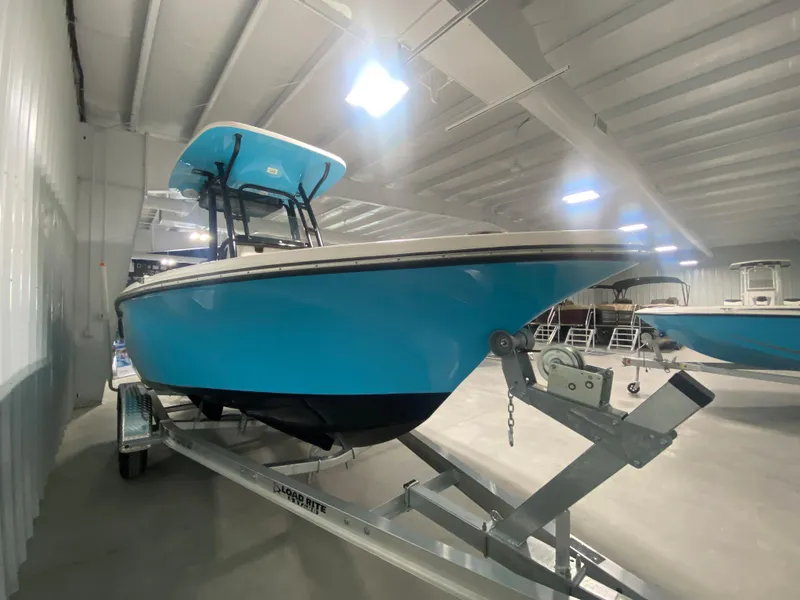 Slide: The Image of 2024 Key West 219 FS boat in a showroom on a trailer. - 2