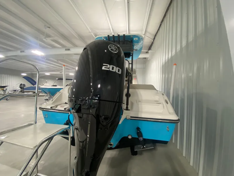 Slide: The Image of 2024 Key West 219 FS boat with a 200 HP outboard motor in a showroom. - 3