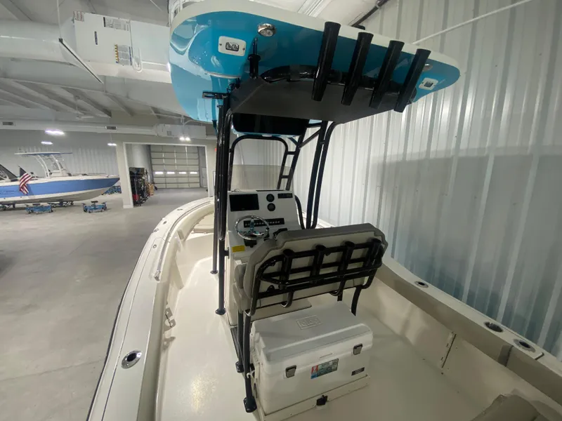 Slide: The Image of 2024 Key West 219 FS boat interior with console and seating in a showroom. - 5