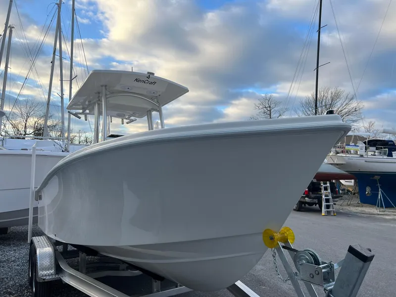 Slide: The Image of 2024 KenCraft 21 boat on trailer under cloudy sky. - 3