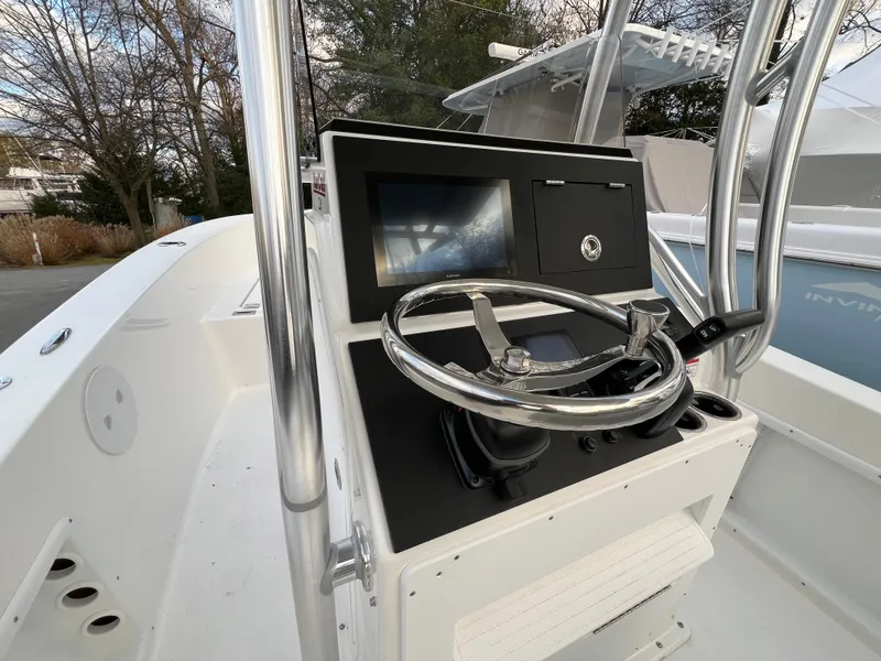 Slide: The Image of 2024 KenCraft 21 boat helm with steering wheel and control panel. - 8