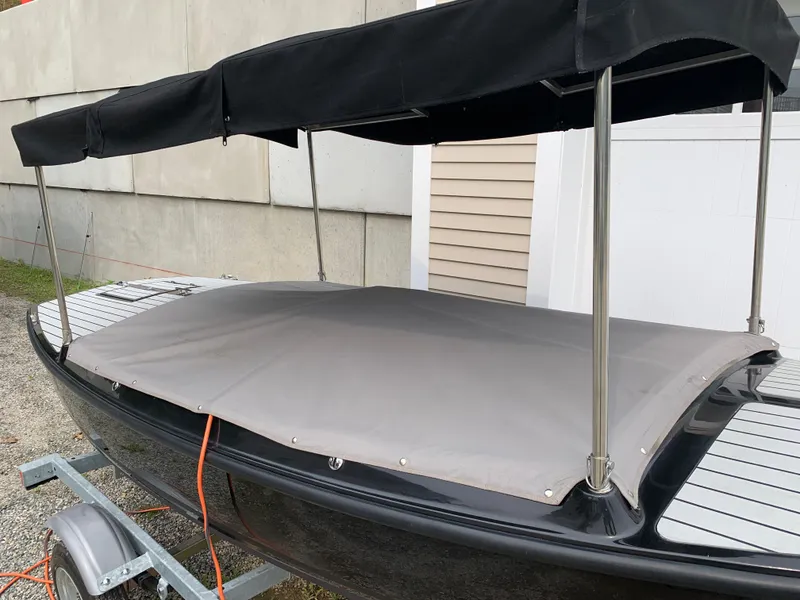 Slide: The Image of 2021 Vision Marine Technologies Quietude 156 electric boat with black canopy and gray cover. - 15