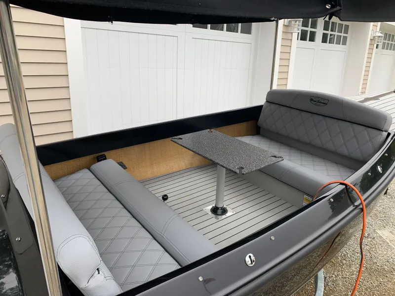 Slide: The Image of 2021 Vision Marine Technologies Quietude 156 boat interior with gray seating and table. - 4