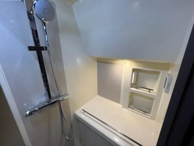 Slide: The Image of 2018 Chris-Craft Launch 38 bathroom with modern shower and built-in shelves. - 14