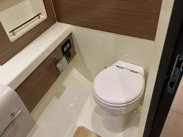 Slide: The Image of 2018 Chris-Craft Launch 38 boat bathroom with modern fixtures and wood accents. - 19