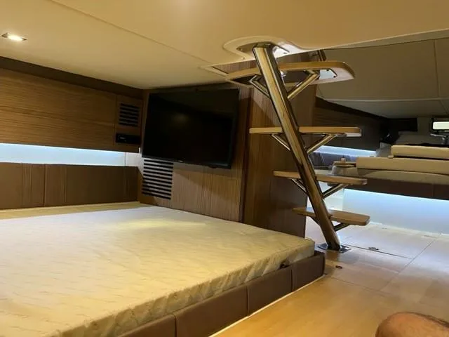 Slide: The Image of 2018 Chris-Craft Launch 38 interior cabin with bed, TV, and modern staircase. - 21
