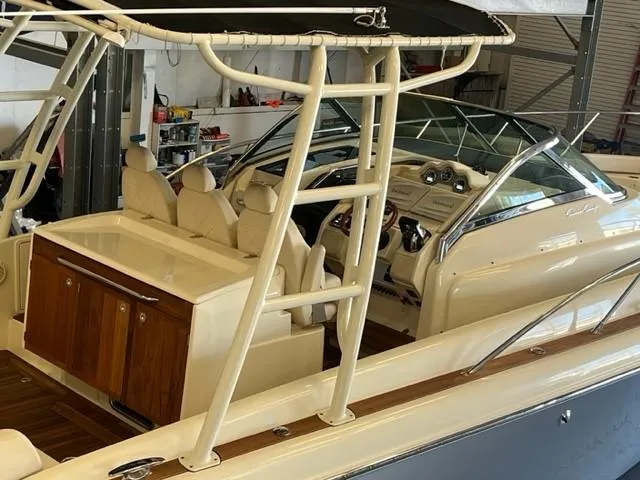 Slide: The Image of 2018 Chris-Craft Launch 38 boat interior with seating and dashboard in a garage. - 6