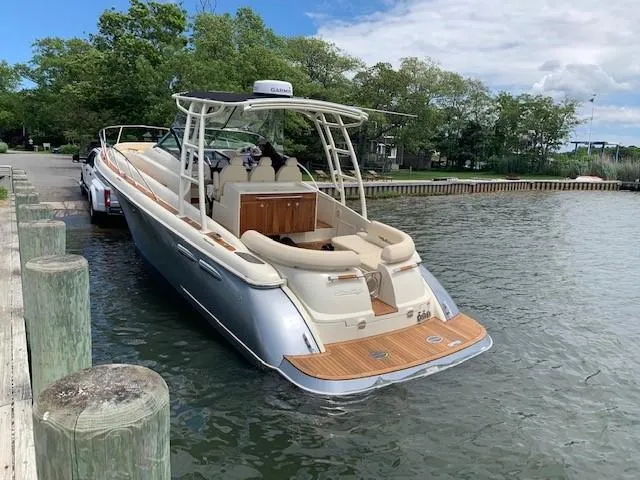 Slide: The Image of 2018 Chris-Craft Launch 38 boat docked on a calm lake. - 8