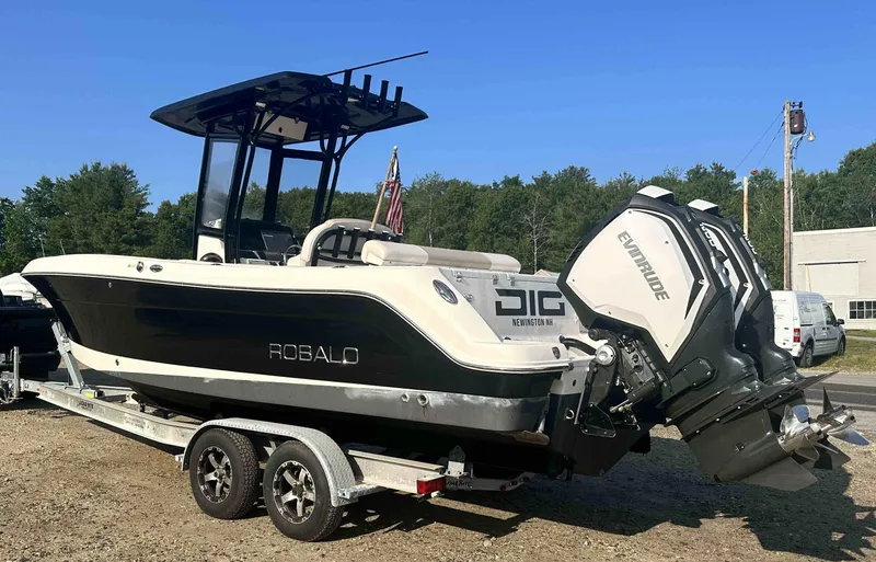 Slide: The Image of 2016 Robalo 2420 Center Console boat on a trailer with Evinrude outboard motor. - 2