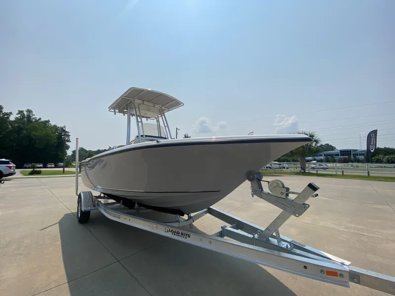 Slide: The Image of 2024 Key West 203 FS boat on a trailer in a parking lot. - 1