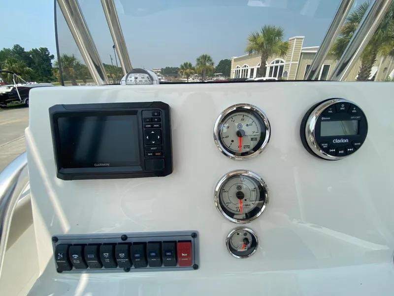 Slide: The Image of 2024 Key West 203 FS boat dashboard with Garmin display and gauges. - 13