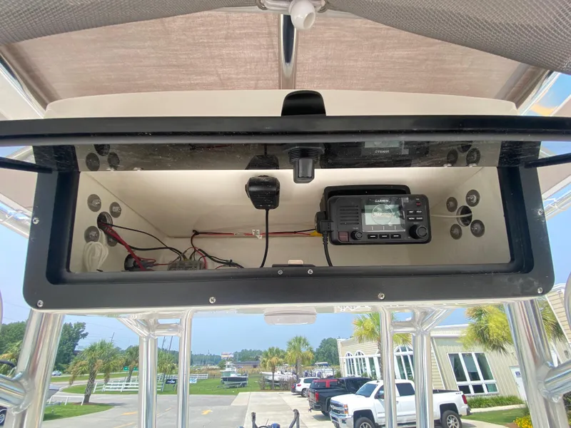 Slide: The Image of 2024 Key West 203 FS boat electronics compartment with radio and wiring. - 15
