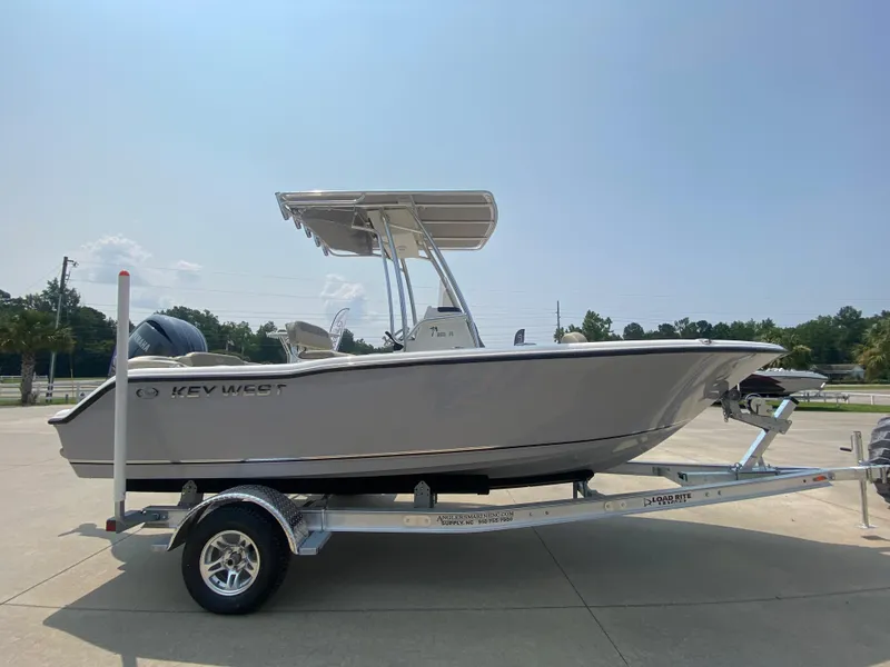 Slide: The Image of 2024 Key West 203 FS boat on a trailer in a parking lot. - 3
