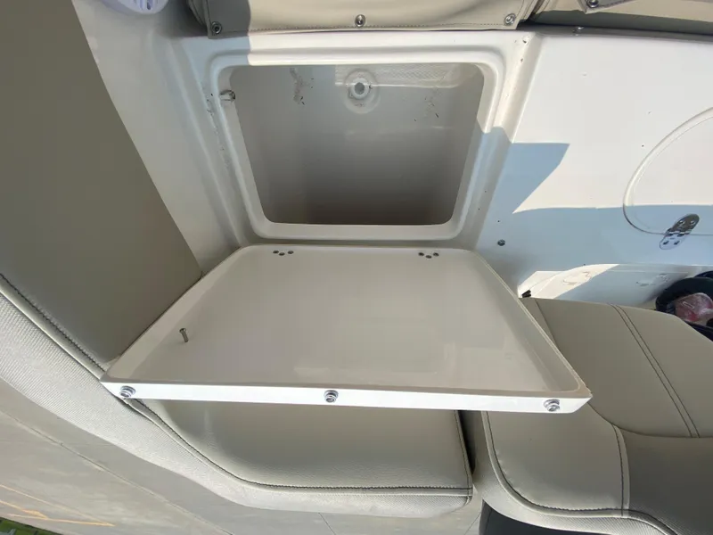 Slide: The Image of 2024 Key West 203 FS boat storage compartment with open lid. - 9