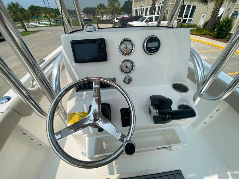 Slide: The Image of 2024 Key West 203 FS boat console with steering wheel and gauges. - 12