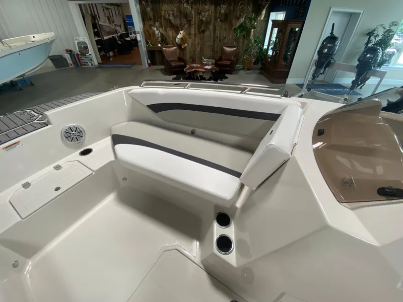 Slide: The Image of 2026 Starcraft SVX 171 boat interior with seating and cup holders in showroom. - 10