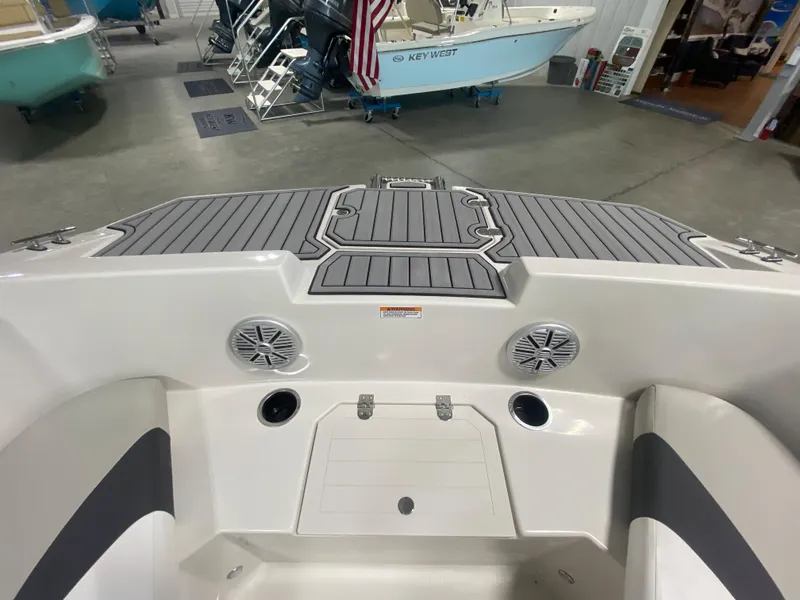 Slide: The Image of 2026 Starcraft SVX 171 boat interior with speakers and seating in a showroom. - 16