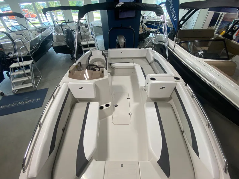 Slide: The Image of 2026 Starcraft SVX 171 boat interior, spacious seating, modern design, displayed in showroom. - 18