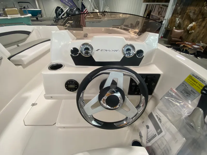 Slide: The Image of 2026 Starcraft SVX 171 boat dashboard with steering wheel and control panel. - 6