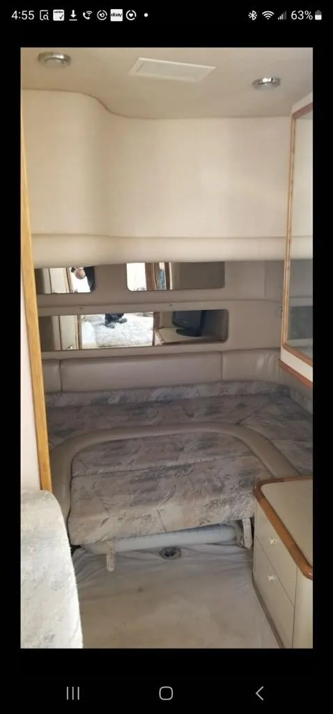 Slide: The Image of Interior cabin of 1995 Sea Ray 450 Sundancer yacht with bed and storage. - 10