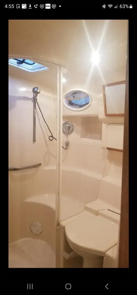 Slide: The Image of 1995 Sea Ray 450 Sundancer bathroom with shower and toilet. - 5