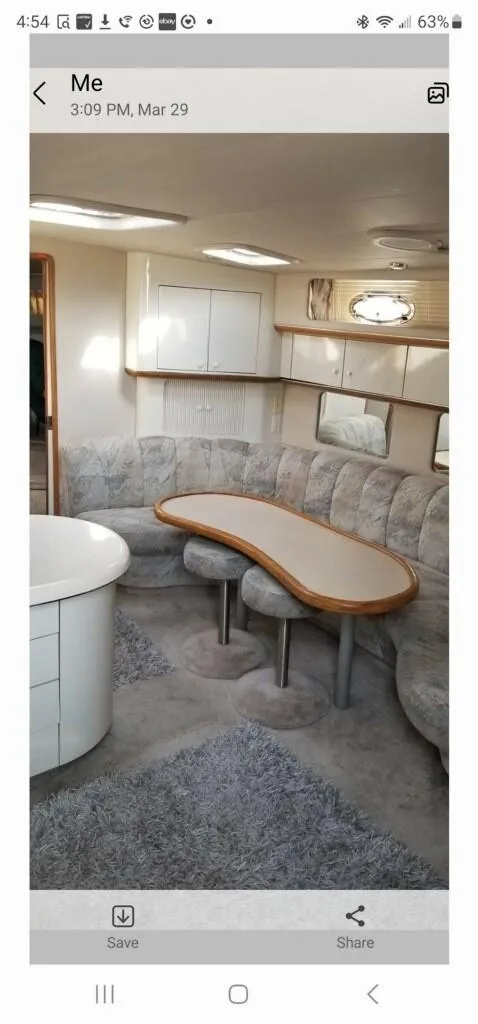 Slide: The Image of Interior of 1995 Sea Ray 450 Sundancer with curved seating and table. - 8