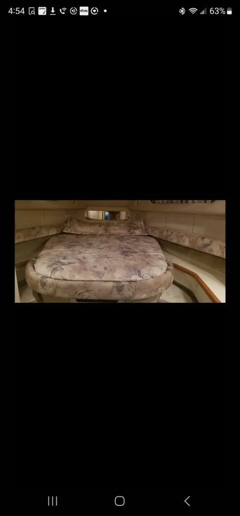 Slide: The Image of 1995 Sea Ray 450 Sundancer cabin interior with bed. - 9