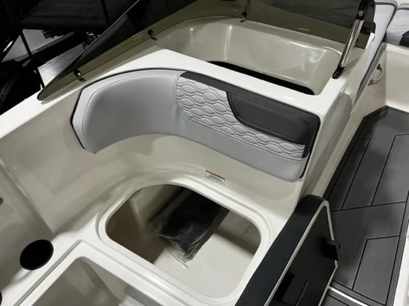 Slide: The Image of 2024 Bayliner Element M17 boat interior with storage compartments and cushioned seating. - 12