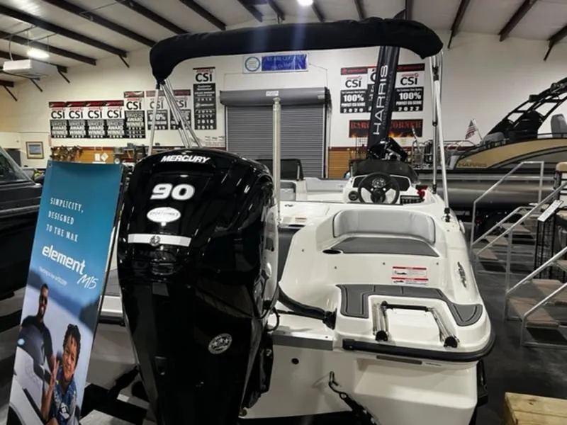 Slide: The Image of 2024 Bayliner Element M17 boat with Mercury 90 engine displayed indoors. - 5