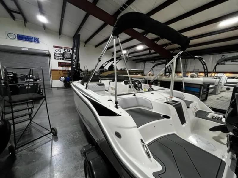Slide: The Image of 2024 Bayliner Element M17 boat in showroom with canopy. - 6