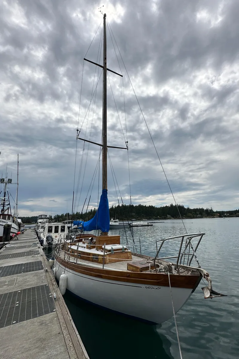 Slide: The Image of 1964 Cheoy Lee Lion Class Sloop docked under cloudy skies. - 1