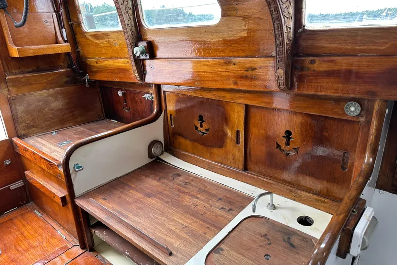 Slide: The Image of 1964 Cheoy Lee Lion Class Sloop interior with wooden cabinetry and nautical-themed decor. - 13