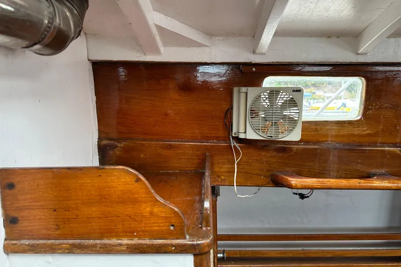 Slide: The Image of Interior of 1964 Cheoy Lee Lion Class Sloop with wooden paneling and small fan. - 19